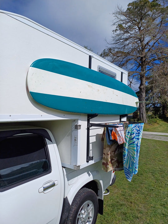 Side mount cargo racks for motorhomes and caravans